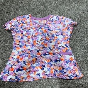 Floral orange, purple, and blue scrub top.